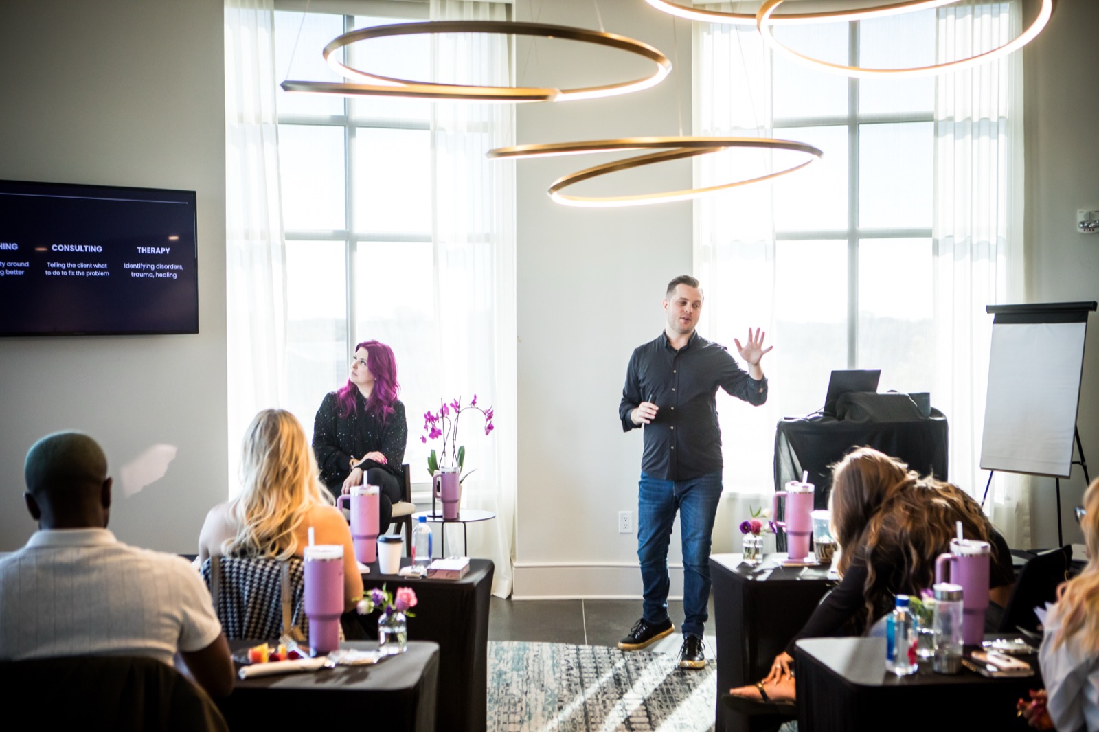Alex speaking with a group at a workshop